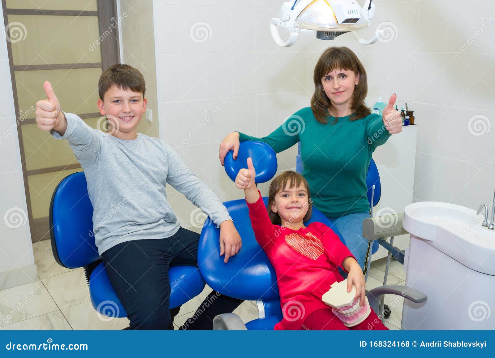 a happy family in a dentistÃ¢â¬â¢s office
